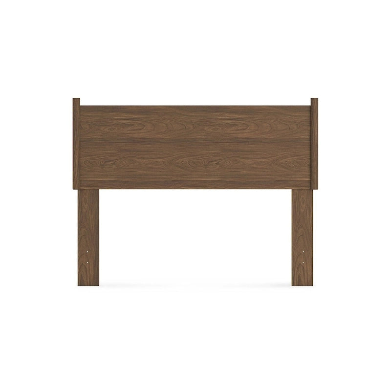 Tête de lit marron, accompagnée d'une coiffeuse et d'une table de chevet.