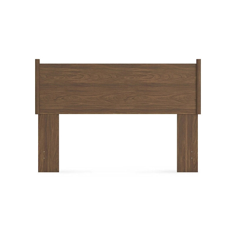 Tête de lit marron, accompagnée d'une coiffeuse et d'une table de chevet.